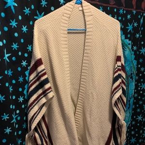 cream colored cardigan//fringe sides.